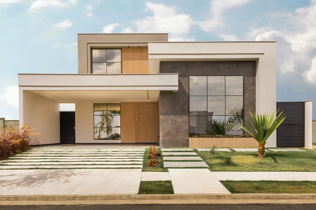 A modern house with a smooth rendered facade and large black-framed windows